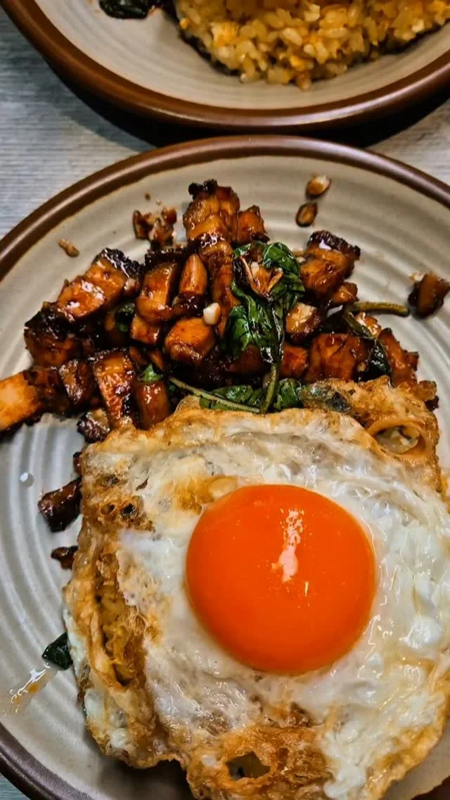 Basil pork belly krapow with a crispy fried egg over wok-hei fried rice at King of KraPOW